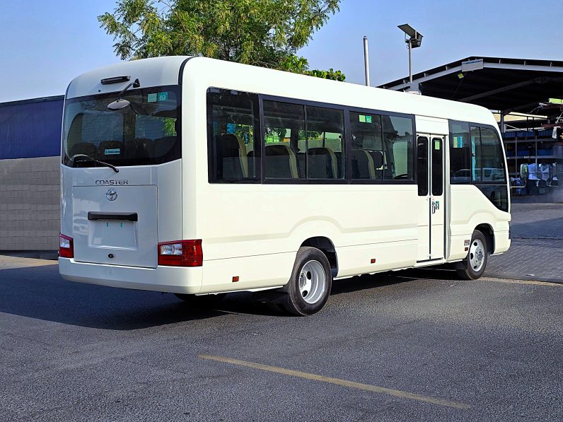 TOYOTA COASTER PETROL 2.7 MT – AUTO DOOR – 23 SEATER – 2 POINT BELT – 2025 MODEL – WHITE 