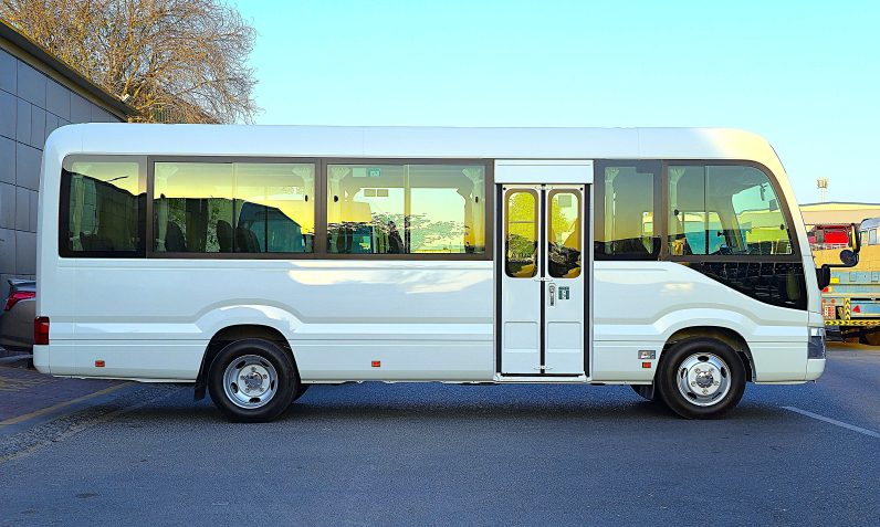 TOYOTA COASTER PETROL 2.7 MT – AUTO DOOR – 23 SEATER – 2 POINT BELT – 2025 MODEL – WHITE 